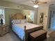 Light and airy bedroom with a wooden bed frame and access to patio at 3761 Peace River Dr, Punta Gorda, FL 33983
