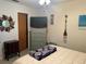 Bedroom with queen bed, dresser, and large TV at 3761 Peace River Dr, Punta Gorda, FL 33983