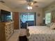Main bedroom with patio access and built-in dresser at 3761 Peace River Dr, Punta Gorda, FL 33983