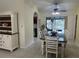 Bright dining room with a table and chairs, view into kitchen at 3761 Peace River Dr, Punta Gorda, FL 33983