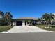 Single story home with a two-car garage and circular driveway at 3761 Peace River Dr, Punta Gorda, FL 33983