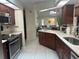 Well-equipped kitchen with dark wood cabinets and island at 3761 Peace River Dr, Punta Gorda, FL 33983