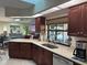 Modern kitchen with dark wood cabinets, granite countertops, and stainless steel appliances at 3761 Peace River Dr, Punta Gorda, FL 33983