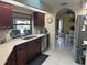 Modern kitchen with dark wood cabinets, granite countertops, and stainless steel appliances at 3761 Peace River Dr, Punta Gorda, FL 33983