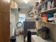 Laundry room with washer, dryer, shelving, and additional storage at 3761 Peace River Dr, Punta Gorda, FL 33983