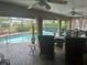 Relaxing screened-in pool area with patio furniture at 3761 Peace River Dr, Punta Gorda, FL 33983