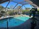 Inviting screened pool area with paver deck at 3761 Peace River Dr, Punta Gorda, FL 33983