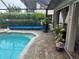 Inviting pool with paver deck and lush landscaping at 3761 Peace River Dr, Punta Gorda, FL 33983