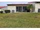 Private screened patio with AC unit and grassy yard at 3830 Bal Harbor Blvd # 17, Punta Gorda, FL 33950