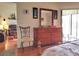 Bedroom with dresser, chair, and view into living room at 3830 Bal Harbor Blvd # 17, Punta Gorda, FL 33950
