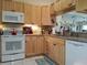 Kitchen with light wood cabinets and granite counters at 3830 Bal Harbor Blvd # 17, Punta Gorda, FL 33950