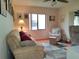 Living room with sofa, chair, and decorative rug at 3830 Bal Harbor Blvd # 17, Punta Gorda, FL 33950