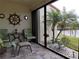 Relaxing sunroom with patio furniture and water views at 3830 Bal Harbor Blvd # 17, Punta Gorda, FL 33950