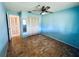 Blue bedroom with wood floors and mirrored closet doors at 420 Sailfish Ln, Punta Gorda, FL 33982