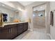 Spa-like bathroom with double vanity, walk-in shower, and pebble floor at 4600 Almar Dr, Punta Gorda, FL 33950