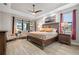 Main bedroom with king-size bed, ceiling fan, and water views at 4600 Almar Dr, Punta Gorda, FL 33950