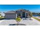 Gray house with tile roof, paver driveway, and palm trees at 4600 Almar Dr, Punta Gorda, FL 33950