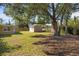 Spacious backyard with shed and large tree providing shade at 5273 Grassland Ter, Port Charlotte, FL 33981