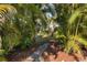 Landscaped backyard with stone path and lush tropical foliage at 5273 Grassland Ter, Port Charlotte, FL 33981