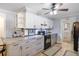 Modern kitchen with granite countertops, white cabinets, and a view of backyard at 5273 Grassland Ter, Port Charlotte, FL 33981