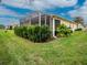 Home features screened patio and well manicured lawn at 6139 Grand Cypress Blvd, North Port, FL 34287