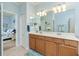 Double vanity bathroom with a view of a bedroom at 6139 Grand Cypress Blvd, North Port, FL 34287