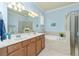 Double vanity bathroom with soaking tub and walk-in shower at 6139 Grand Cypress Blvd, North Port, FL 34287
