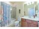 Bathroom with tub shower and wood vanity at 6139 Grand Cypress Blvd, North Port, FL 34287