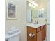 Bathroom with vanity, toilet, and large mirror at 6139 Grand Cypress Blvd, North Port, FL 34287