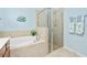 Spa-like bathroom includes a large walk-in shower and a relaxing tub at 6139 Grand Cypress Blvd, North Port, FL 34287