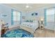 Beach-themed bedroom with light wood furniture and blue accents at 6139 Grand Cypress Blvd, North Port, FL 34287