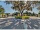 Gated community entrance with brick pavers and lush landscaping at 6139 Grand Cypress Blvd, North Port, FL 34287