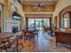 Community room with fireplace, seating area, and pool view at 6139 Grand Cypress Blvd, North Port, FL 34287