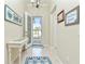 Bright entryway with tiled floor, white table, and coastal decor at 6139 Grand Cypress Blvd, North Port, FL 34287