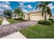 Single Gathering home with paved driveway and tropical landscaping at 6139 Grand Cypress Blvd, North Port, FL 34287