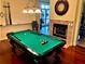 Community game room featuring a billiard table and fireplace at 6139 Grand Cypress Blvd, North Port, FL 34287