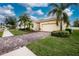 Attractive single-Gathering home with a paved driveway and lush landscaping at 6139 Grand Cypress Blvd, North Port, FL 34287