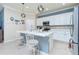 Well-equipped kitchen featuring white cabinetry, quartz countertops, and an island at 6139 Grand Cypress Blvd, North Port, FL 34287