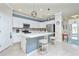 Modern kitchen with white cabinets, stainless steel appliances, and a breakfast bar at 6139 Grand Cypress Blvd, North Port, FL 34287