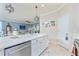 Spacious kitchen with island, stainless steel appliances, and white cabinets at 6139 Grand Cypress Blvd, North Port, FL 34287