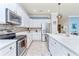 Modern kitchen with stainless steel appliances and white cabinets at 6139 Grand Cypress Blvd, North Port, FL 34287