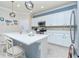 Stylish kitchen with white cabinets, quartz countertops and a breakfast bar at 6139 Grand Cypress Blvd, North Port, FL 34287