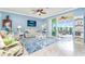 Spacious living room featuring a ceiling fan, tiled floors, and comfortable seating at 6139 Grand Cypress Blvd, North Port, FL 34287