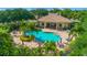 Community pool with patio furniture and landscaping at 6139 Grand Cypress Blvd, North Port, FL 34287