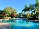 Inviting resort-style pool with ample deck space and red umbrellas at 6139 Grand Cypress Blvd, North Port, FL 34287