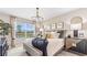 Spacious primary bedroom with large window and stylish decor at 9578 Turtle Grass Cir, Punta Gorda, FL 33950