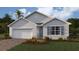 Single-story home with white siding, gray shutters, and a two-car garage at 9578 Turtle Grass Cir, Punta Gorda, FL 33950