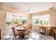 Bright dining room with wood table and chairs, and view to backyard at 10810 Cedar Breaks Dr, Port Richey, FL 34668