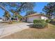 Exterior view of a single-story house with a garage and neatly landscaped front yard at 10810 Cedar Breaks Dr, Port Richey, FL 34668