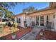 Exterior view of a house with a covered entryway and nicely landscaped front yard at 10810 Cedar Breaks Dr, Port Richey, FL 34668